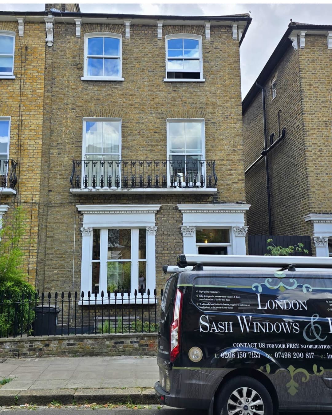 LSWD van outside a yellow-brick terrace with restored white sashes